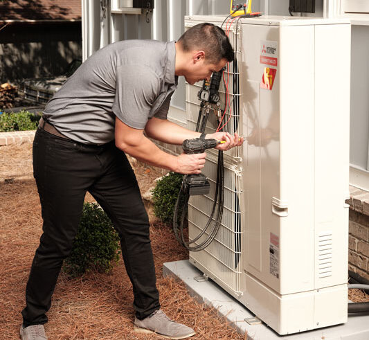Total Services HVAC technician servicing a customer. Total Services provides HVAC careers in Savannah, Pooler, Richmond Hills, and surrounding areas.